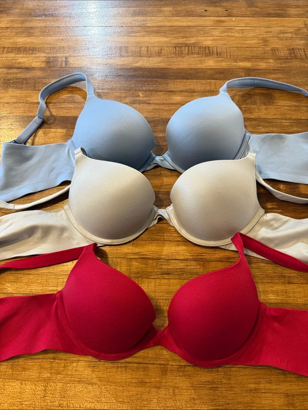 Three-pack SPANX Smooth T-Shirt Bras in Light Blue, Cream, and Red
